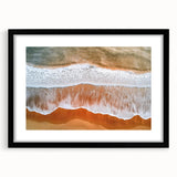 Black-framed landscape artwork depicting serene beaches with soft waves and golden sand, featuring a white mat for an elegant presentation, ideal for coastal decor.