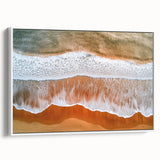 Framed canvas artwork showcasing a serene beach landscape in soft pastel colors, featuring gentle waves and a clear sky, with a crisp white frame enhancing its elegance. Perfect for coastal-themed decor.