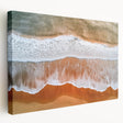 Stretched canvas artwork depicting a serene beach landscape, showcasing vibrant colors of blue water and golden sand, ideal for coastal home decor.