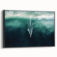 Framed canvas artwork showcasing a serene beach landscape with soft blue skies and gentle waves, presented in a sleek black frame for an elegant touch. Ideal for coastal-themed decor.