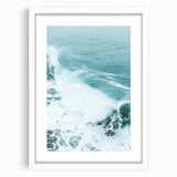 Abstract art print featuring swirls of blue and green on a white framed canvas, suitable for dining room or bedroom decor.