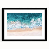 Black-framed landscape artwork depicting a serene beach scene, featuring soft waves and a clear sky, ideal for enhancing home decor with a coastal vibe.