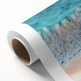 Vibrant rolled canvas artwork depicting a serene beach landscape with soft waves and golden sands, perfect for coastal-themed decor, packaged securely for delivery.