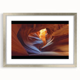 Framed landscape artwork depicting majestic canyons, featuring a sleek silver frame and white matting, perfect for enhancing modern home decor.
