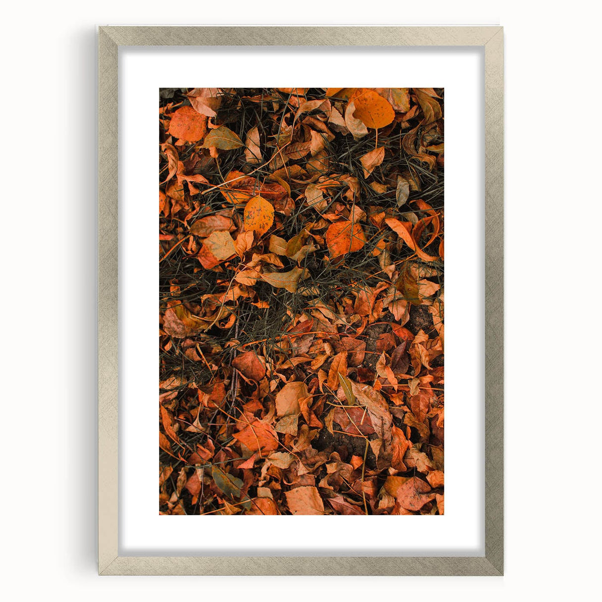 Textured abstract art print depicting fall foliage in earthy tones on a framed silver mat, ideal for bedroom decor.