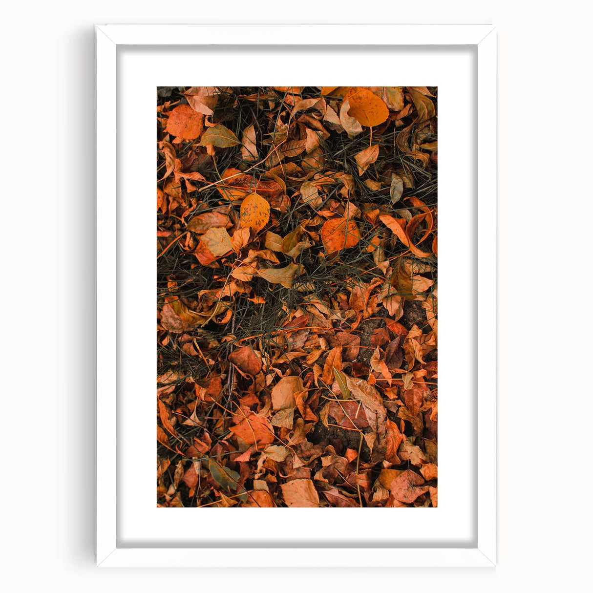 Abstract art print depicting autumn leaves in orange and red tones on a white framed canvas, suitable for dining room decor.