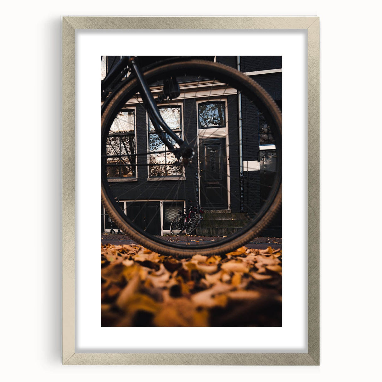 Textured abstract art print in warm autumn hues on a framed silver mat, ideal for bedroom decor.