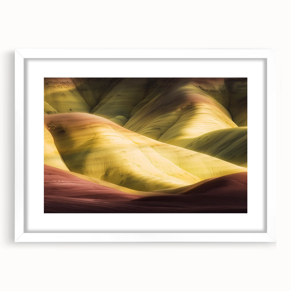 Landscape print of canyons framed with a white mat, showcasing rich earth tones and intricate details, perfect for enhancing home decor and adding elegance.