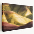 Stretched canvas art depicting a stunning landscape of colorful canyons, showcasing vibrant hues of orange and purple under a clear blue sky, perfect for home decor.
