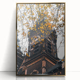 Large art print of a mid-century modernist autumn scene in gold and orange tones on a framed acrylic.