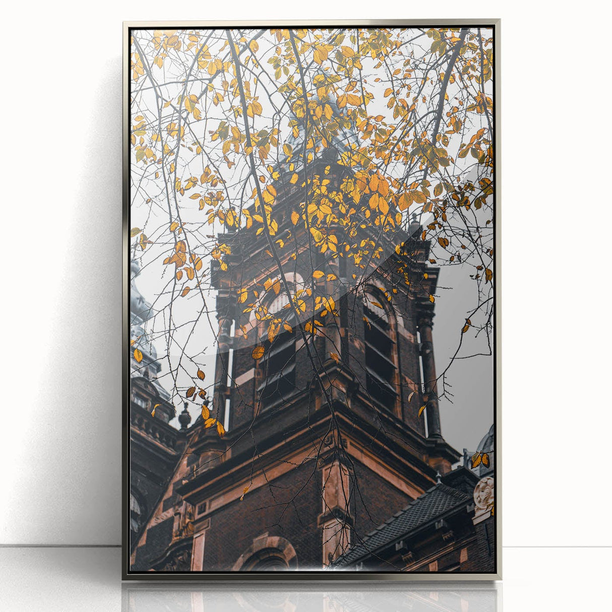 Mid-century modernist art depicting fall trees in vibrant orange and yellow, silver-framed acrylic print.
