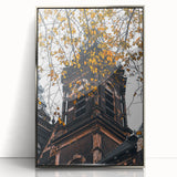 Mid-century modernist art depicting fall trees in vibrant orange and yellow, silver-framed acrylic print.