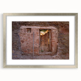 Abstract art print depicting an Ethiopian landscape in muted earth tones, framed in silver, suitable for dining room decor.