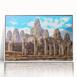 Acrylic print of a Cambodian landscape in art deco style, with vibrant green and blue tones, framed in white.