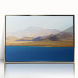 Framed acrylic print of a Tibetan landscape in muted earth tones.