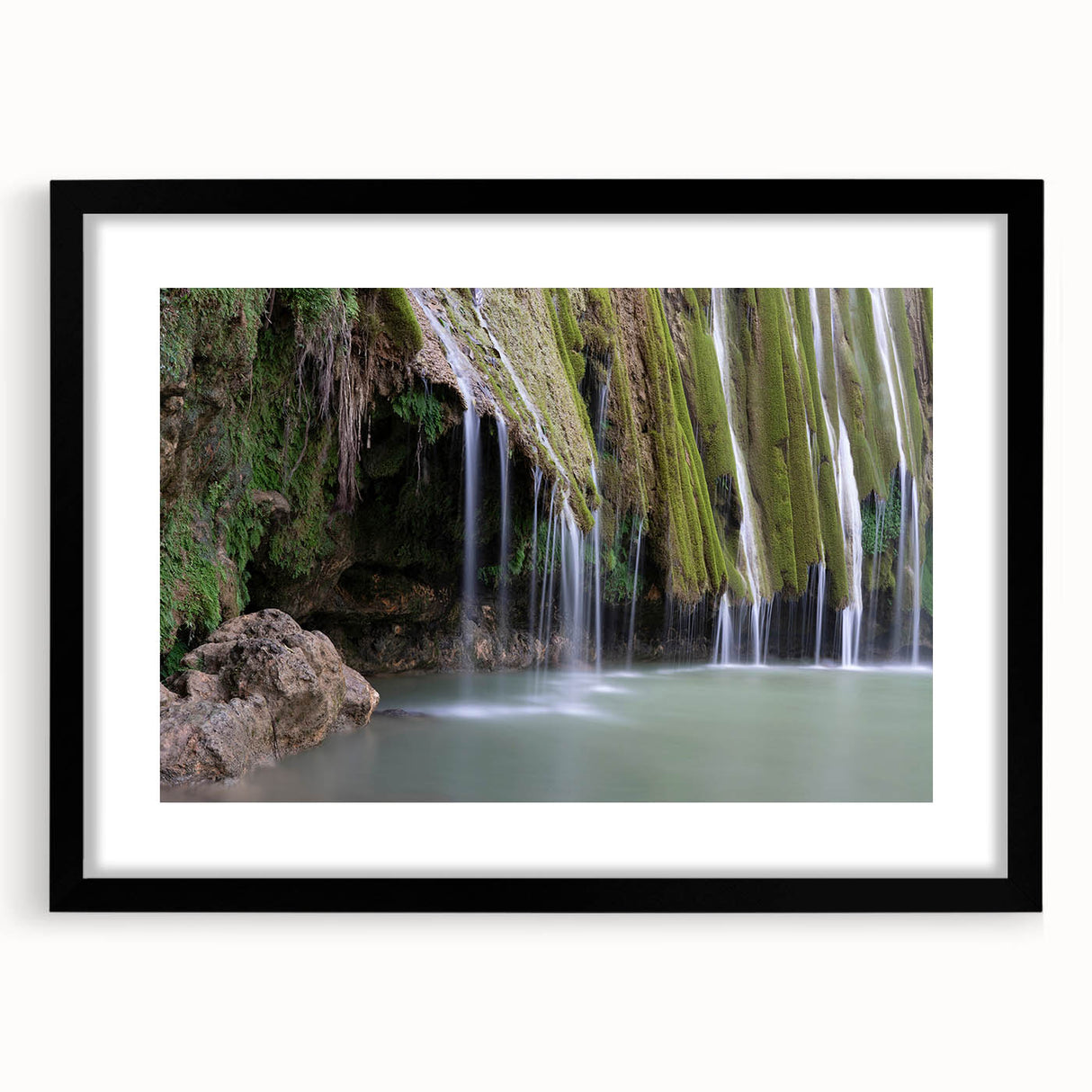 Colorful abstract art print of Caribbean scenery in a large black frame, suitable for living room decor.