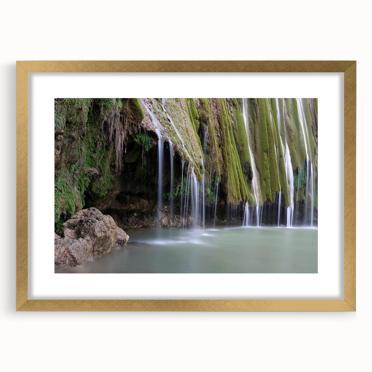 Textured abstract art print of a Caribbean scenery in muted blue and green tones, framed in gold.
