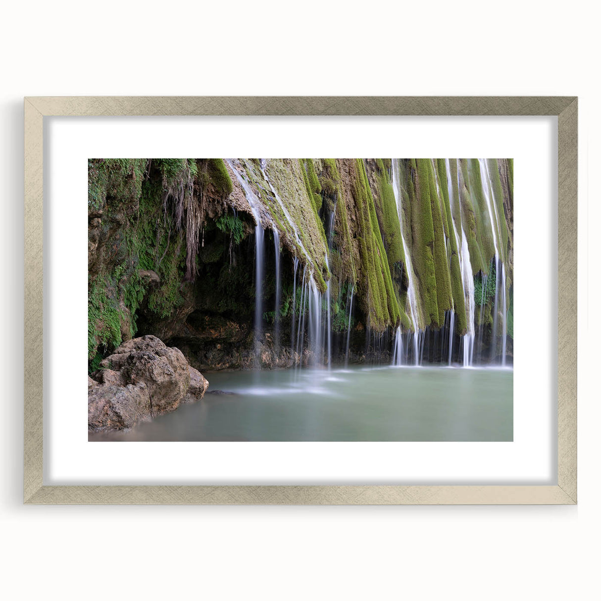 Abstract art print depicting a Caribbean scenery in vibrant blue and green tones, framed in silver.