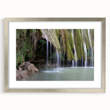 Abstract art print depicting a Caribbean scenery in vibrant blue and green tones, framed in silver.