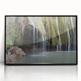 Large abstract wall art depicting a Caribbean landscape in muted blue and green tones, framed in black acrylic.
