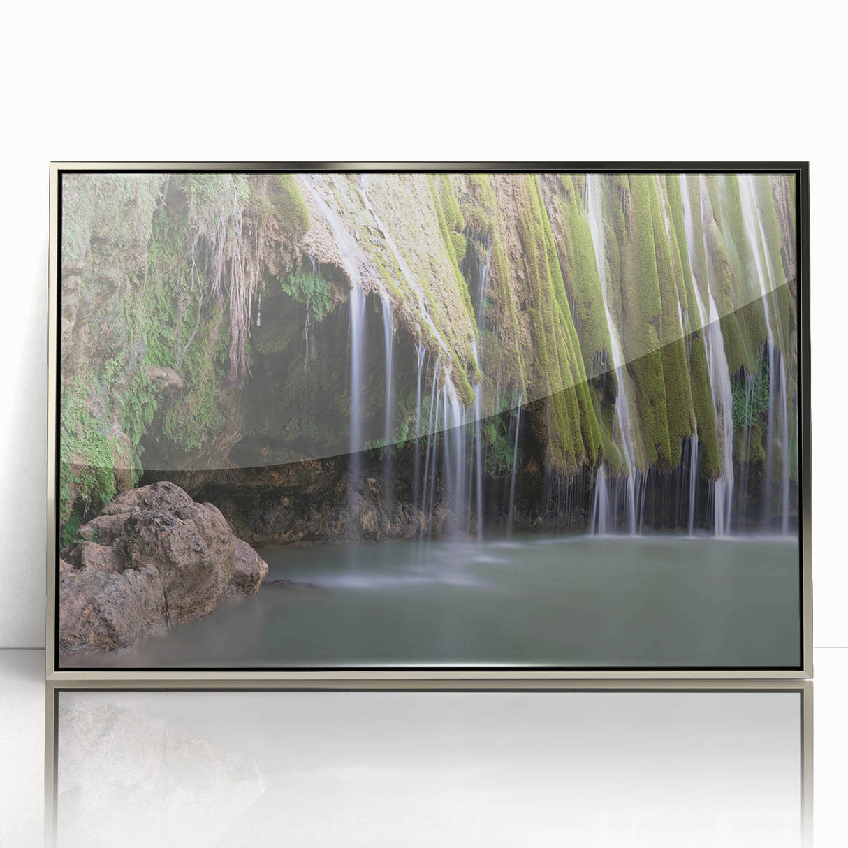 Art deco poster of a Caribbean scene with vibrant blue and green tones on a silver-framed acrylic.