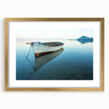 Abstract art print of a Caribbean scenery in muted blue and green tones, framed in gold, suitable for dining room decor.