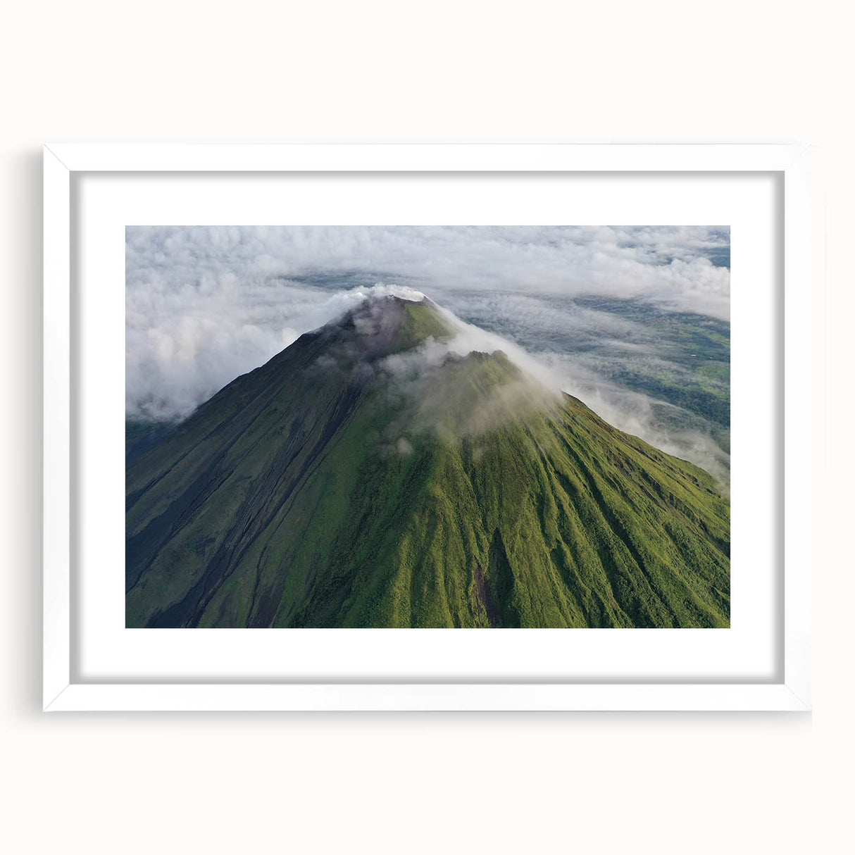 Abstract art print depicting a lush Costa Rican landscape in vibrant green and blue tones, framed with a white mat.