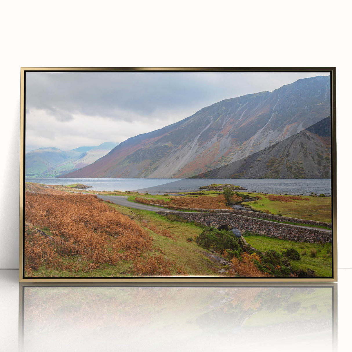 Art deco poster of Cumbria, England scenery in muted gold and green tones on framed acrylic.