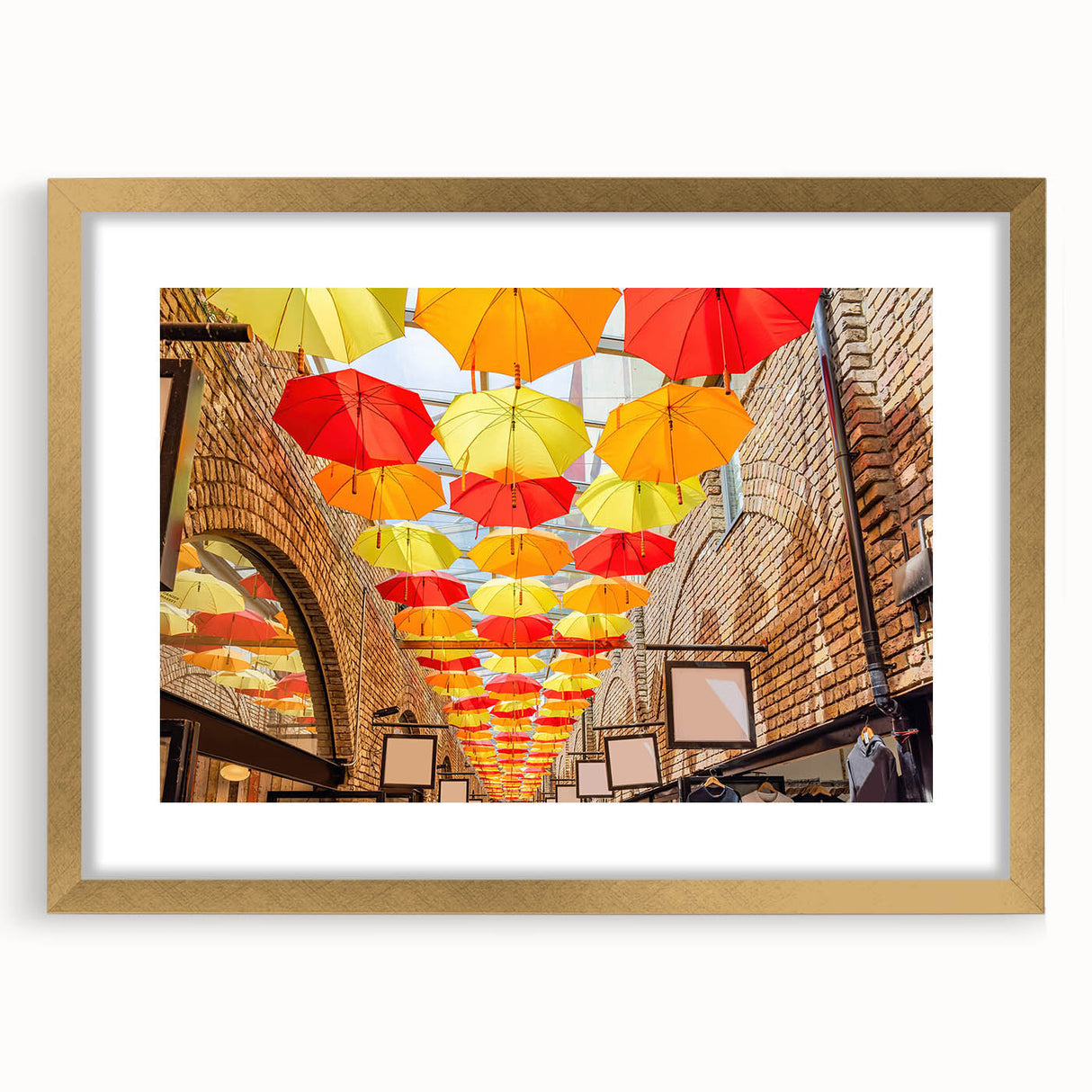 Abstract art print of Piccadilly, England in muted gold and blue tones, framed with a gold mat.