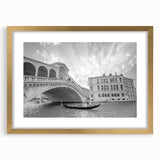Abstract art print of Venice scenery in muted gold and blue tones on a framed canvas, suitable for dining room decor.