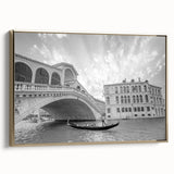 Framed canvas featuring a vintage-style landscape painting of Venice with muted gold and black tones.
