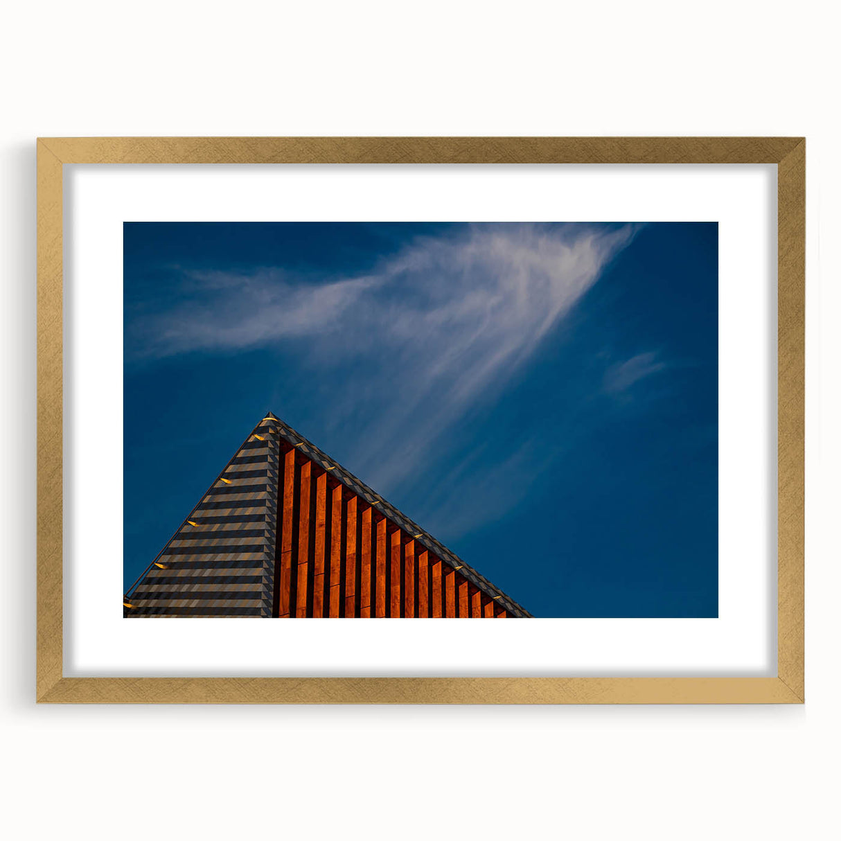 Abstract art print featuring a European Lithuanian landscape in muted gold and green tones, framed with a gold mat.