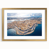 Abstract art print of a European Malta scenery in muted earth tones on a gold-framed mat, suitable for dining room decor.