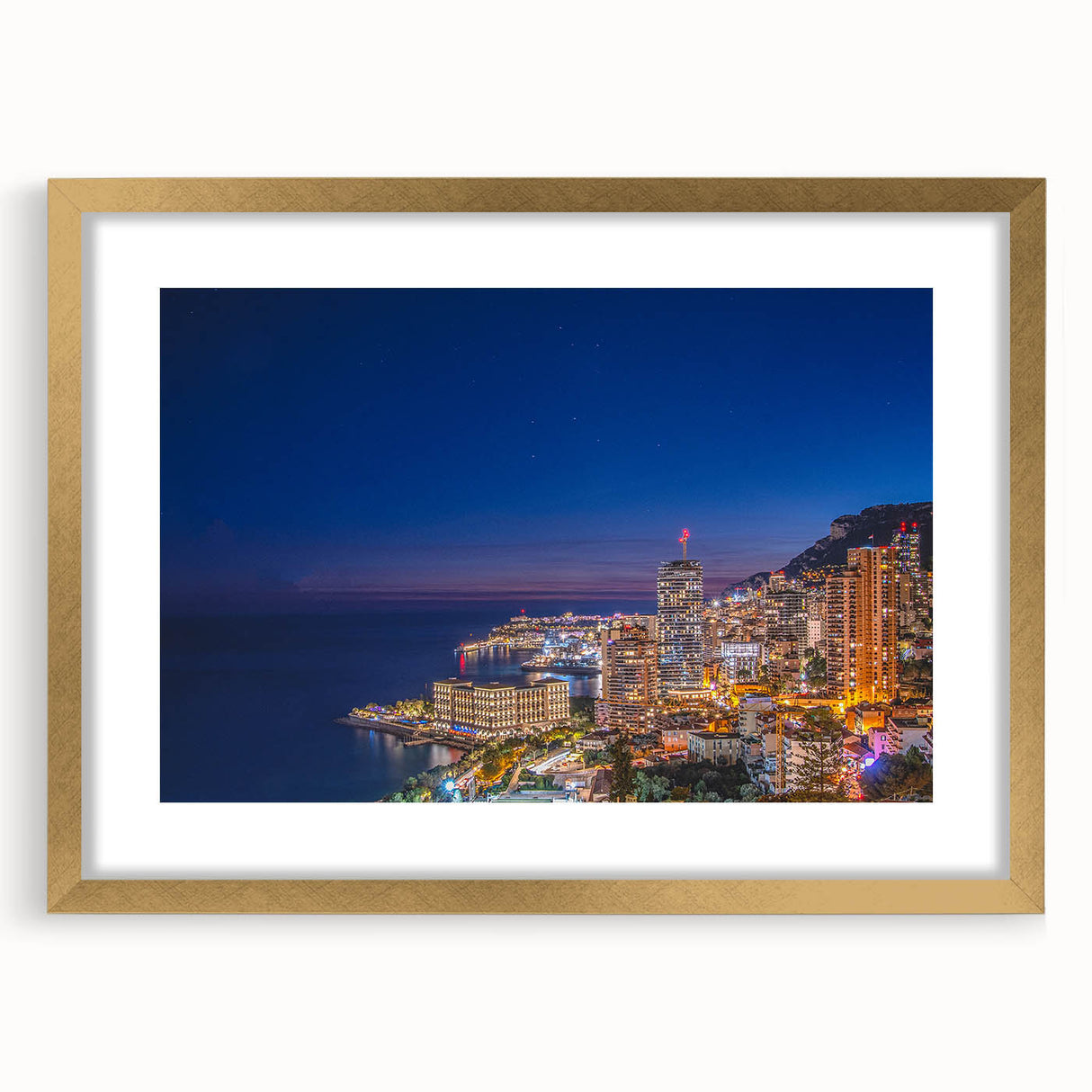 Abstract art print of Monaco scenery in muted gold and blue tones, framed with a gold mat, suitable for dining room decor.