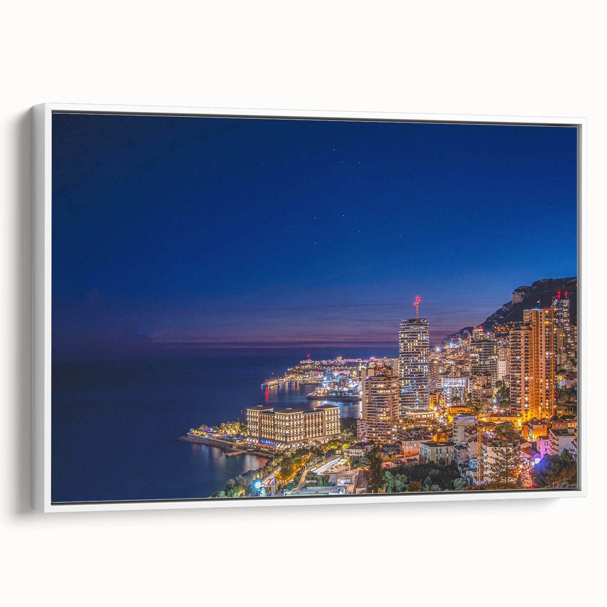 Vintage poster art of Monaco scenery on a framed canvas, featuring vibrant colors against a black background.