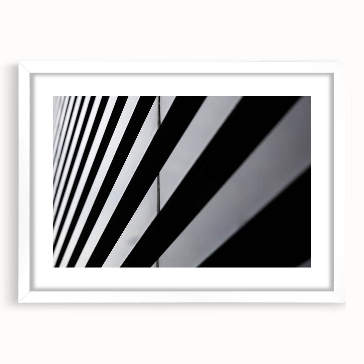 Textured art depicting an abstract Amsterdam canal scene in muted blue and gray tones, framed with a white mat.