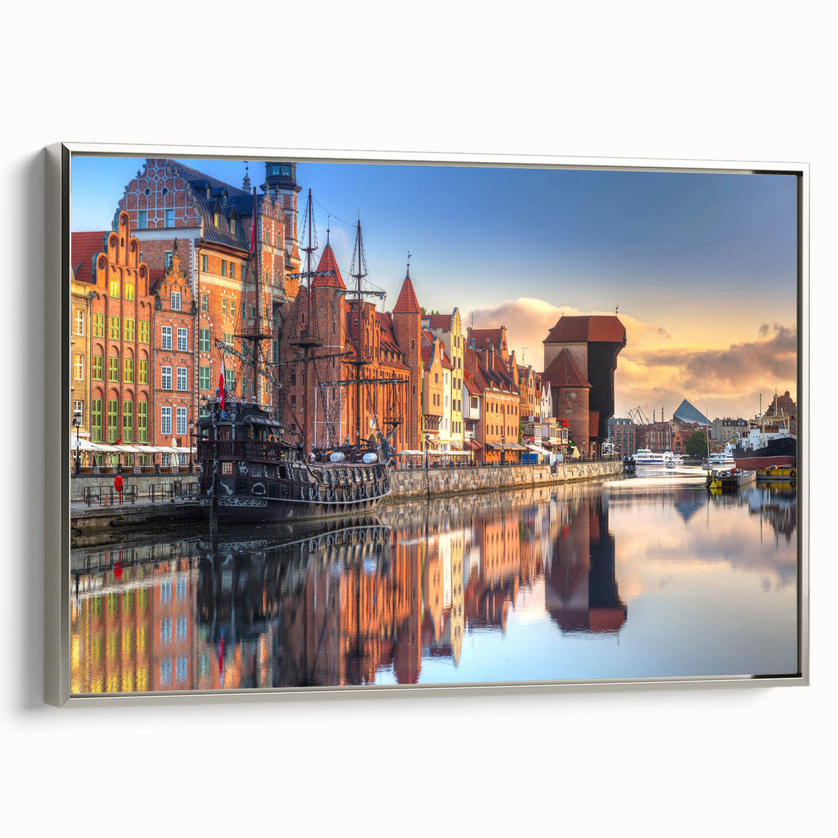 Landscape art painting of a scenic European town in Poland, displayed on a silver-framed canvas, featuring vibrant.
