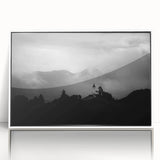 Large art print of a Slovenian landscape, featuring lush green hills under a blue sky, in a white framed acrylic.