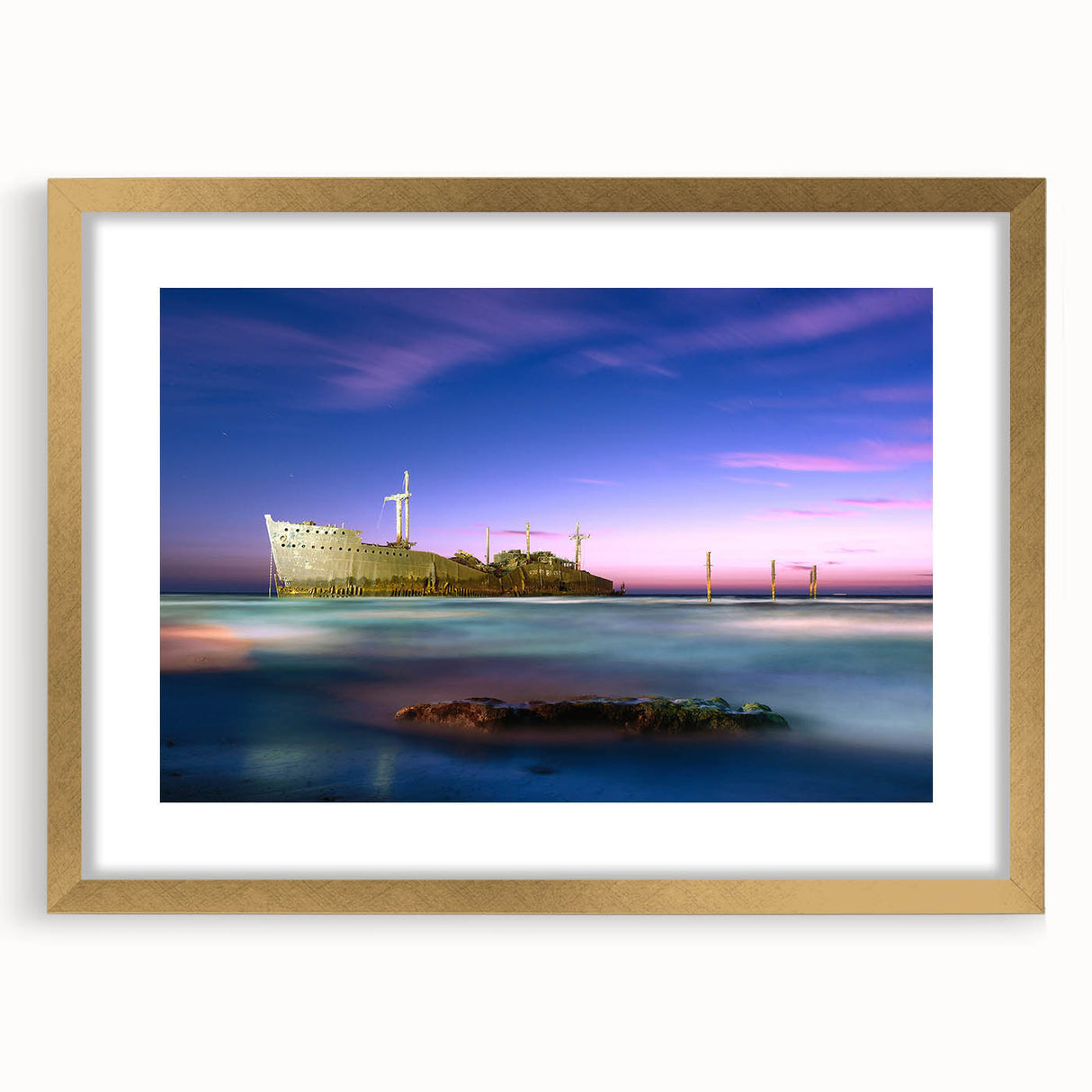Extra large wall art featuring an abstract depiction of a Middle Eastern scenery in textured gold tones, framed with a mat.