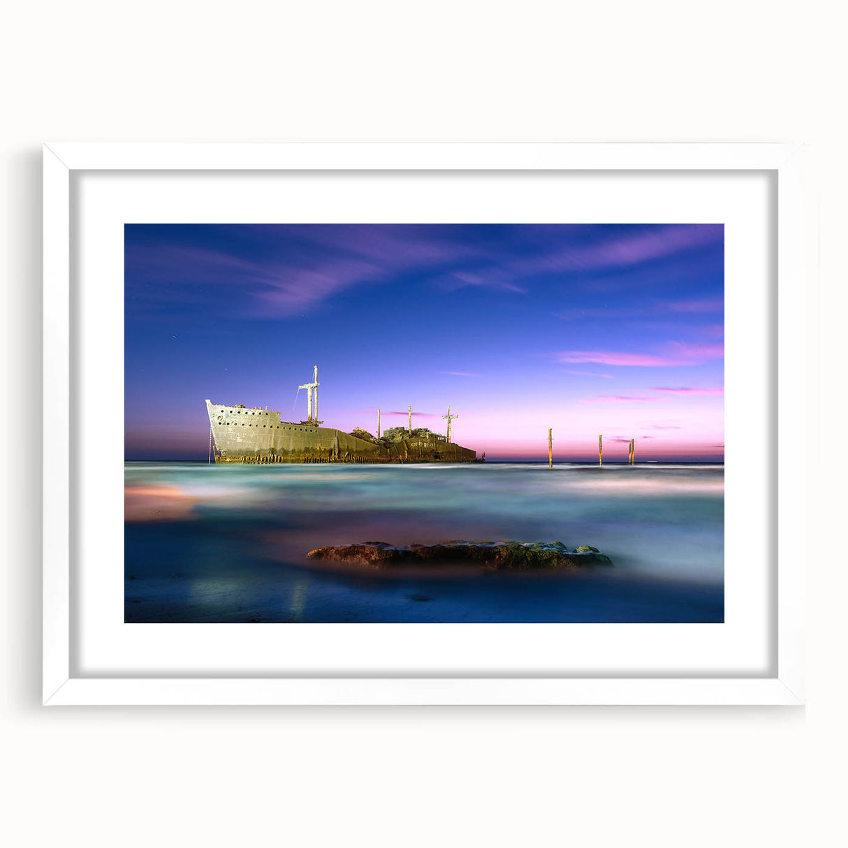 Abstract art print of a Middle Eastern scenery in muted earth tones on a white matted frame, suitable for dining room decor.