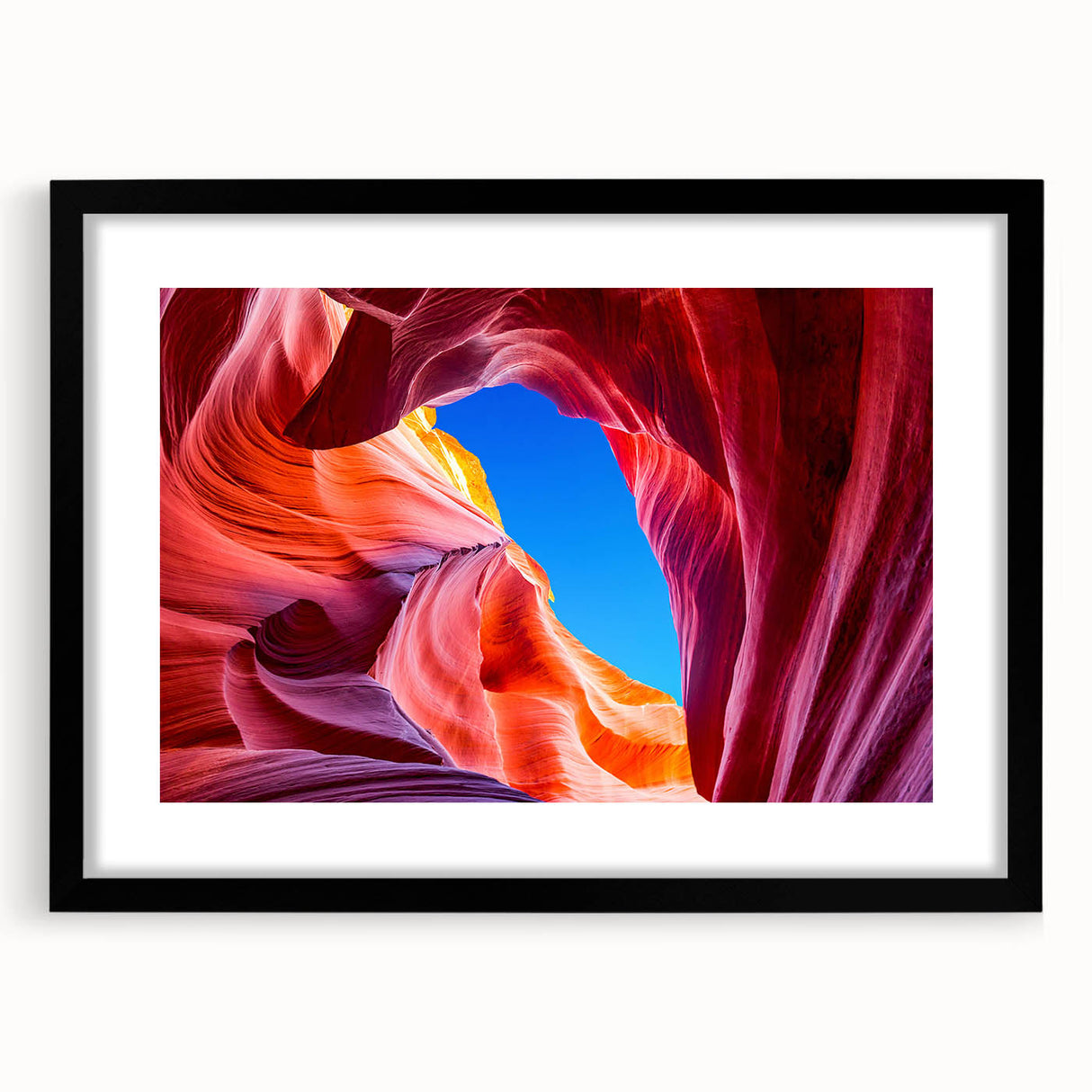 Extra large, colorful abstract art print of Arizona Antelope Canyon in a black frame, ideal for living room decor.