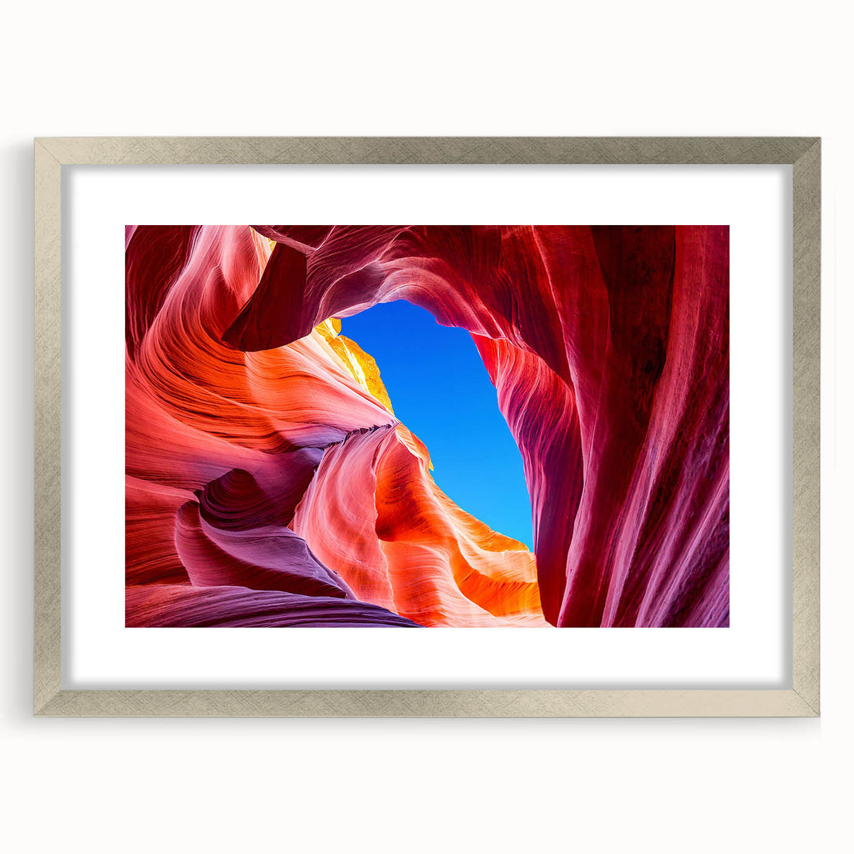 Textured art depicting abstract Antelope Canyon in Arizona, with earthy red and orange tones on a framed silver mat.