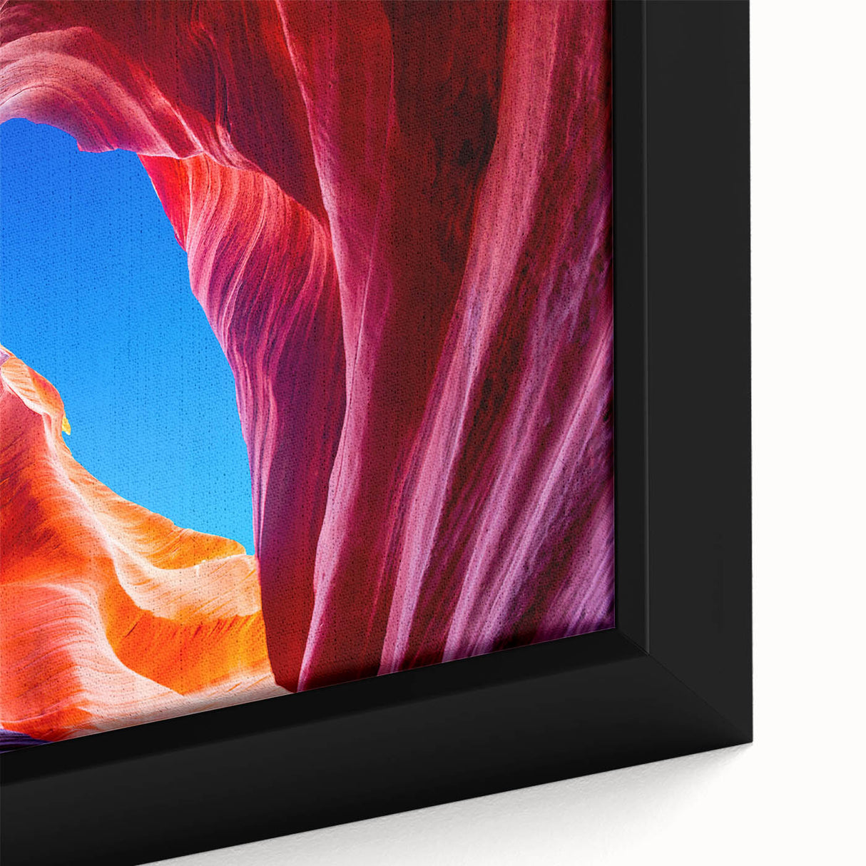 Close-up of a black framed canvas featuring a textured depiction of Antelope Canyon in vibrant orange and red tones.