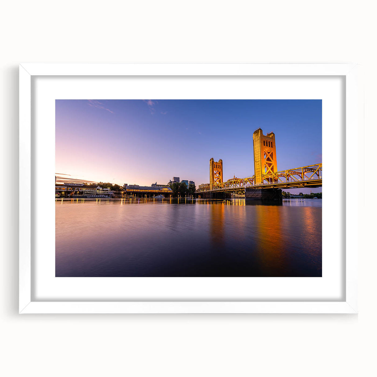 Abstract art print of Sacramento skyline in muted gray and blue tones on a framed white mat, suitable for dining room decor.