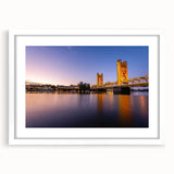 Abstract art print of Sacramento skyline in muted gray and blue tones on a framed white mat, suitable for dining room decor.