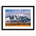 Colorful abstract art print of Montana scenery in vibrant hues on a large framed canvas, ideal for living room decor.