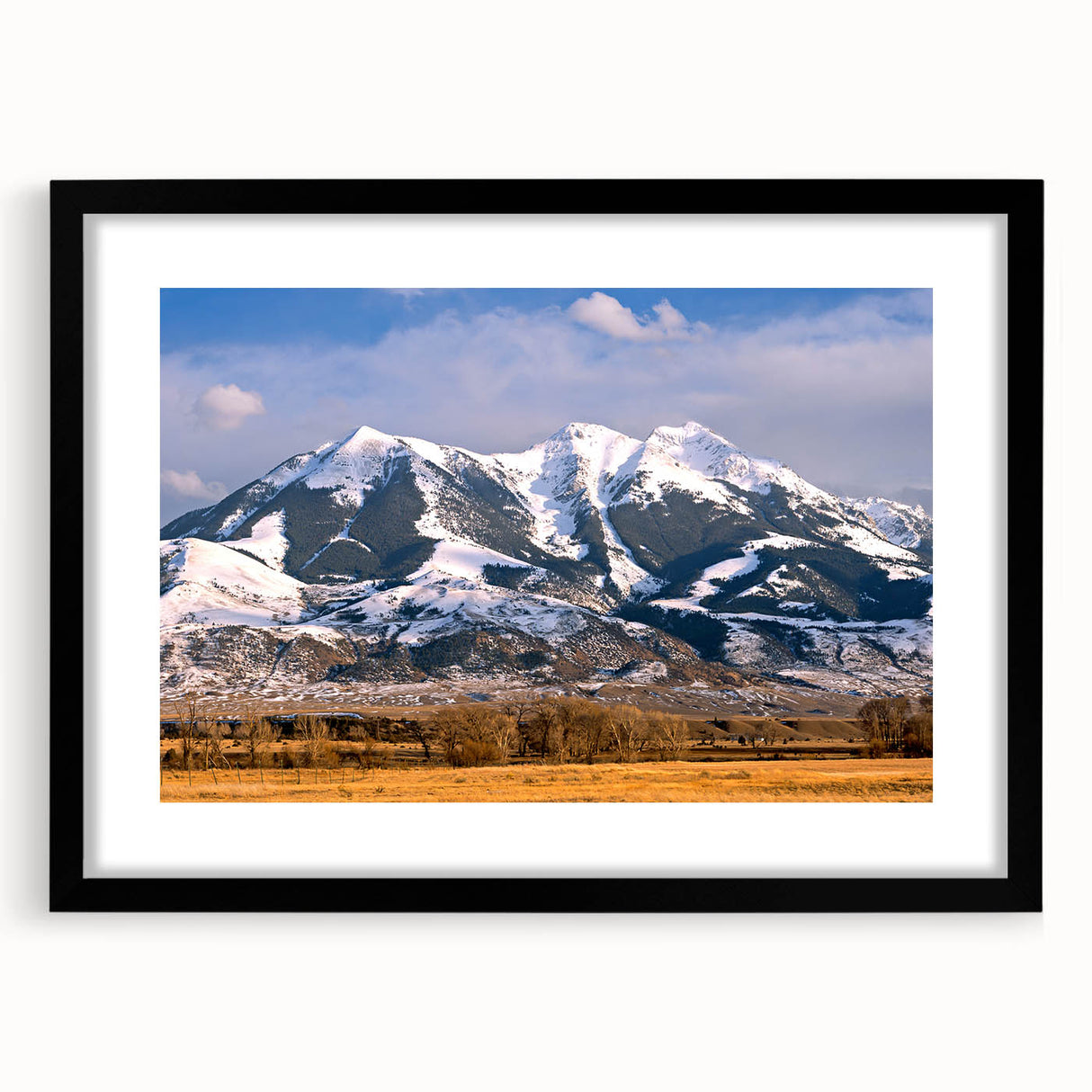 Colorful abstract art print of Montana scenery in vibrant hues on a large framed canvas, ideal for living room decor.
