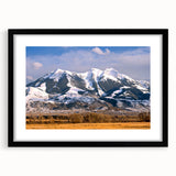 Colorful abstract art print of Montana scenery in vibrant hues on a large framed canvas, ideal for living room decor.