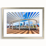 Textured art print of Charlotte skyline in muted grays and blues on a framed silver mat, suitable for bedroom decor.