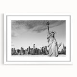 Abstract art print of the Statue of Liberty in muted blue and gray tones on a white framed canvas.